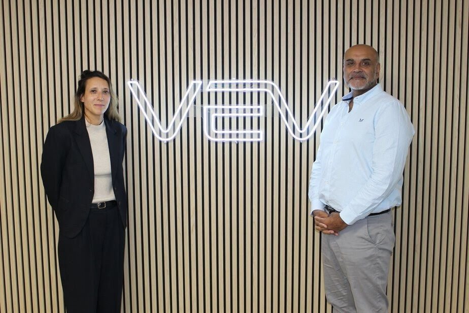 صورة تُظهر مركبات نقل كهربائية وشواحن في بيئة أعمال، مع شعارات VEV وجول كابيتال وتيسي الفنلندية ترمز إلى تمويل وتوسيع الشحن الأوروبي。