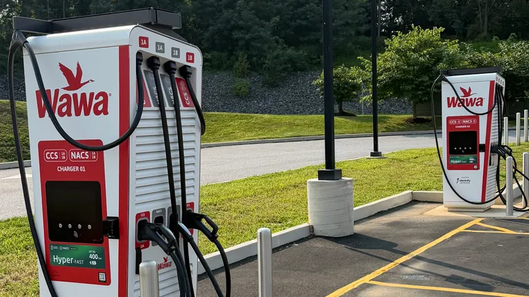 صورة لمحطة شحن سيارات كهربائية تحمل علامة واوا وشعار Electrify America
